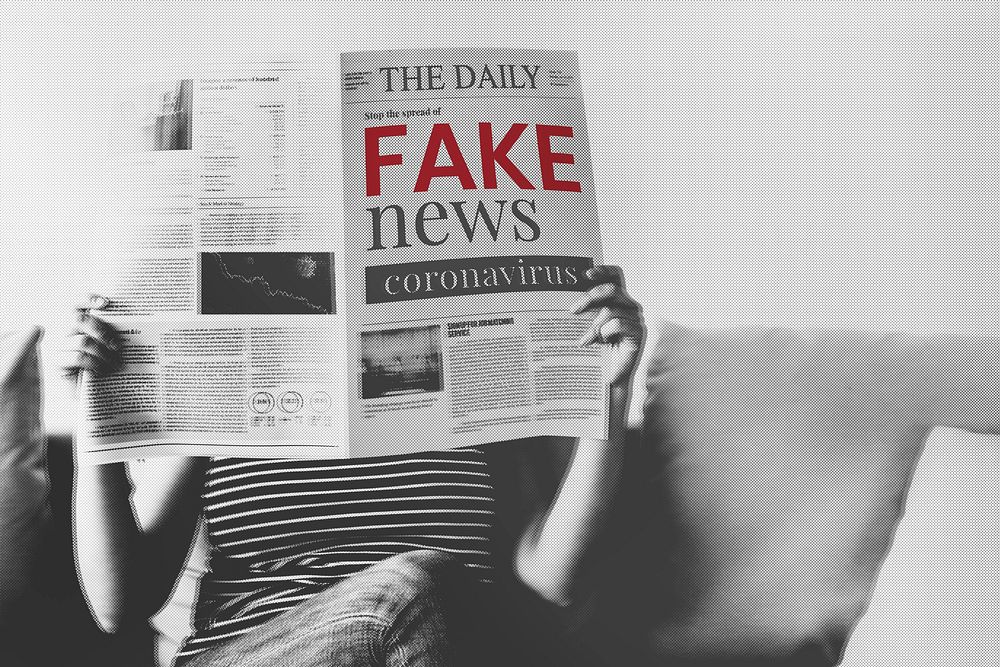 Woman reading coronavirus fake news from a newspaper during coronavirus quarantine