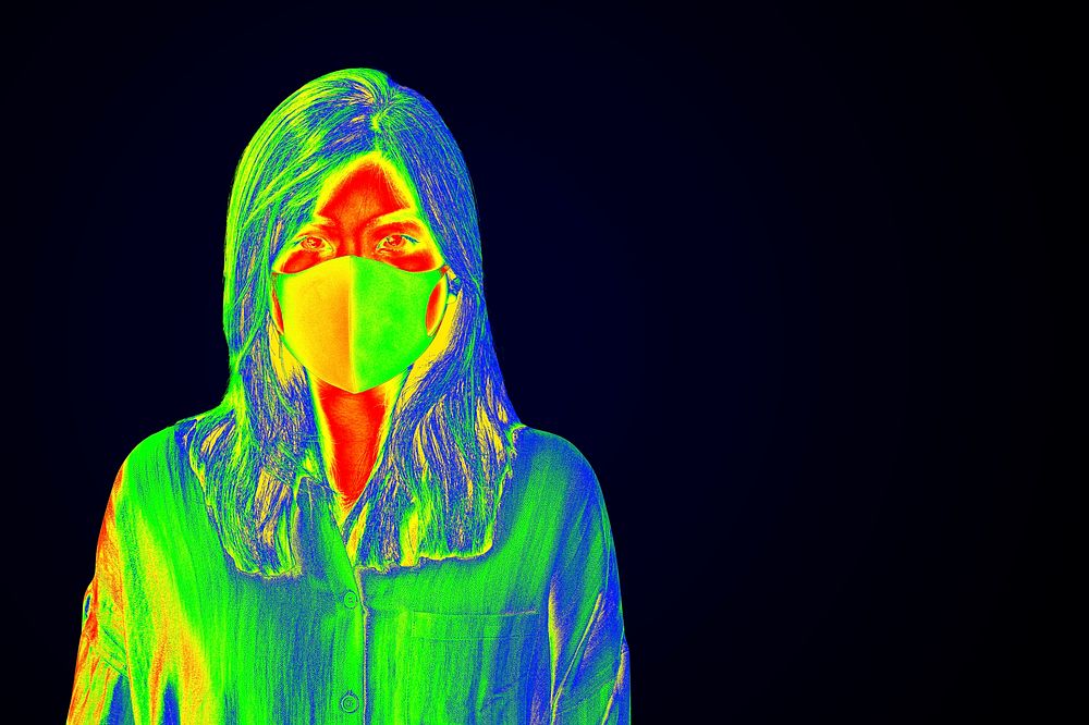 Woman wearing a face mask during coronavirus pandemic thermal image