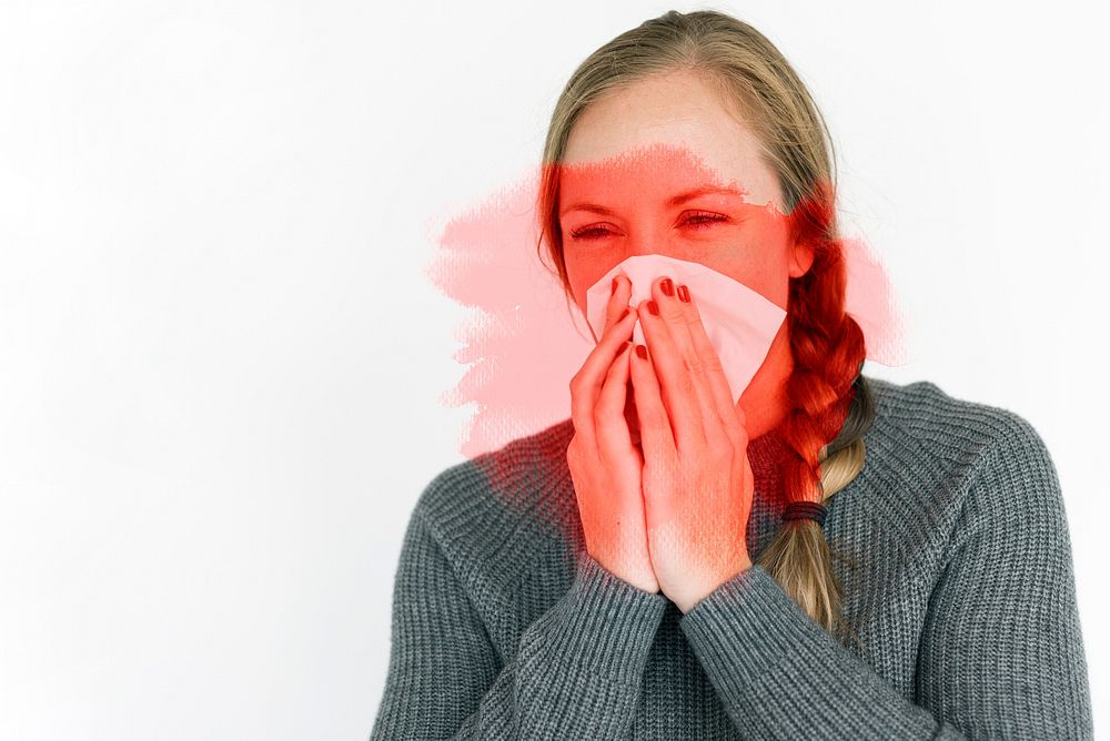 Sick woman sneezing and spreading the virus
