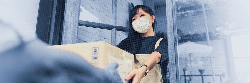 Woman in a face mask receiving a delivery box