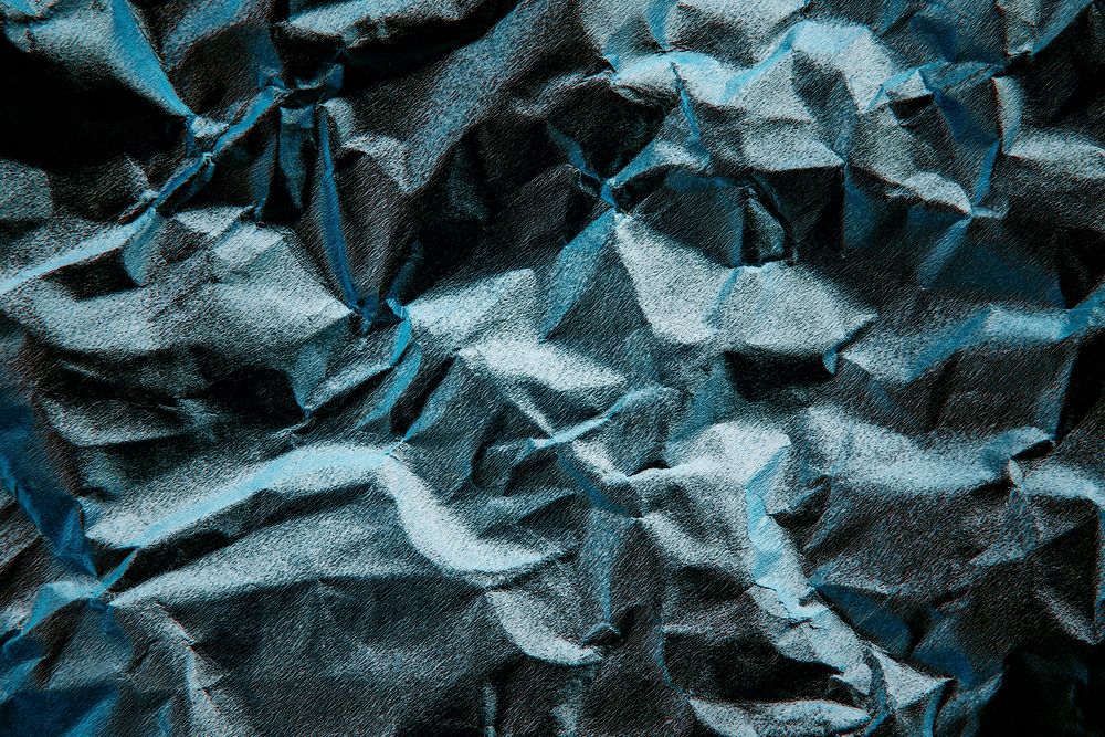 Blue scrunched paper textured background