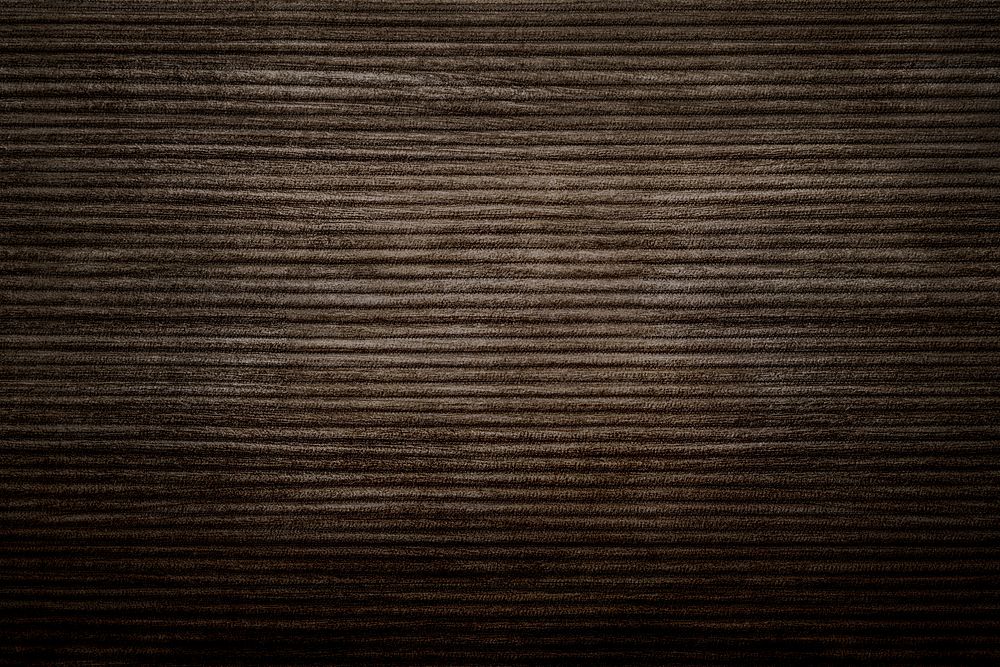 Dark brown corduroy fabric textured background