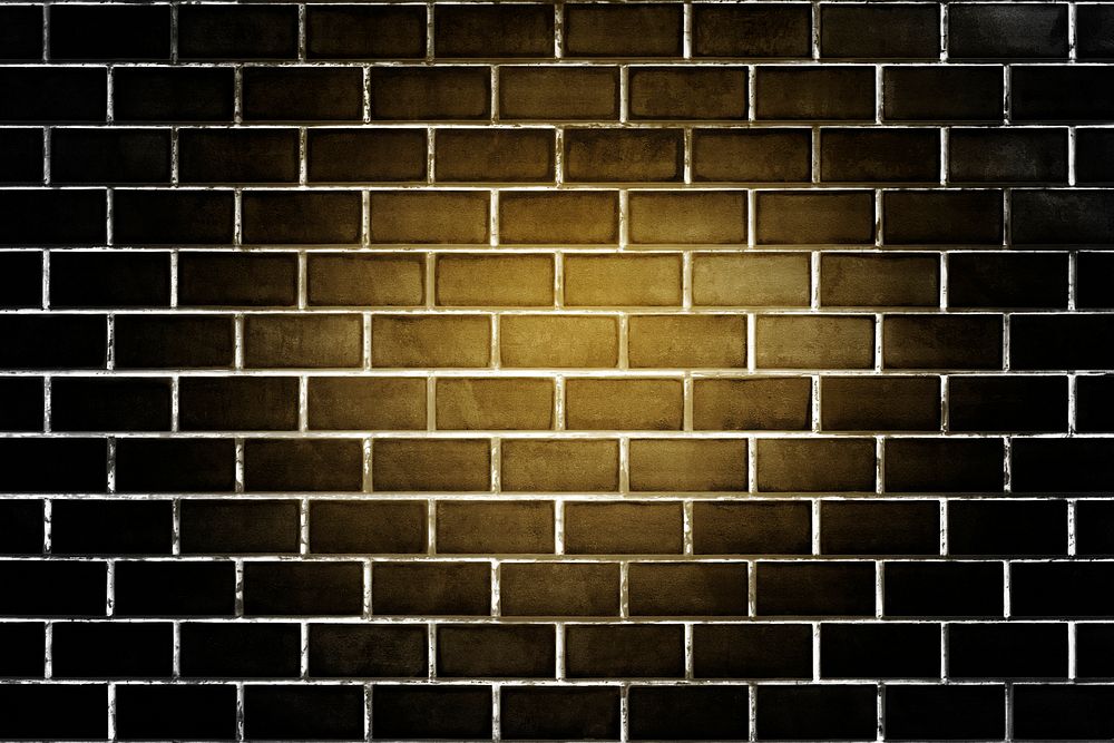 Yellow light on a black brick wall textured background