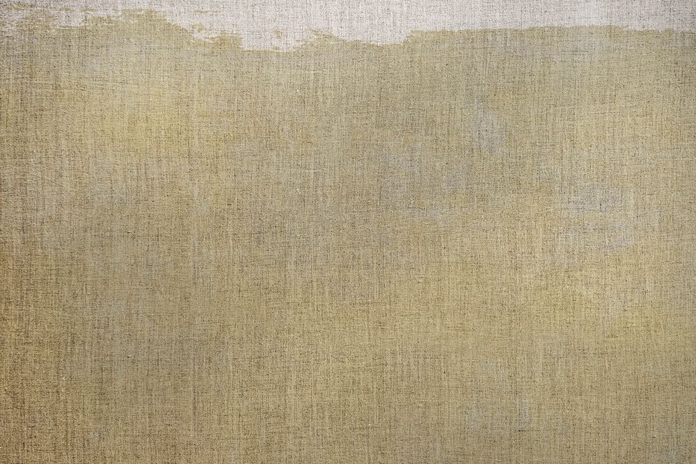 Dark brown paint on a canvas textured background