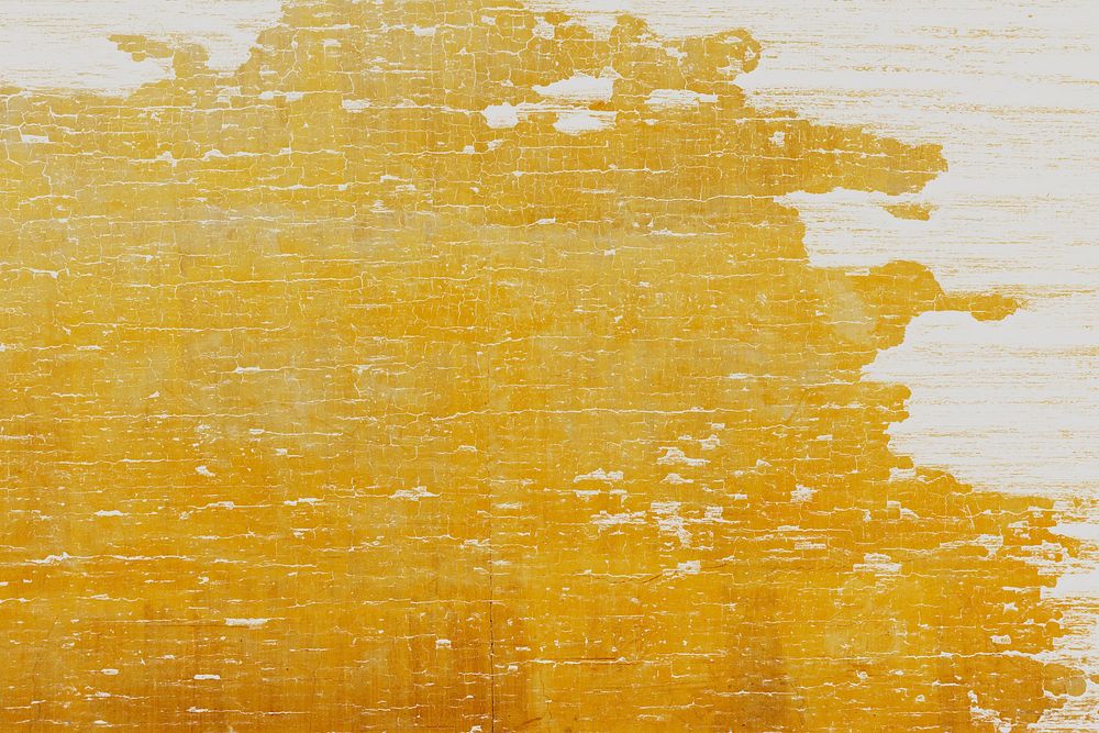 Cracked yellow paint on a wooden plank background