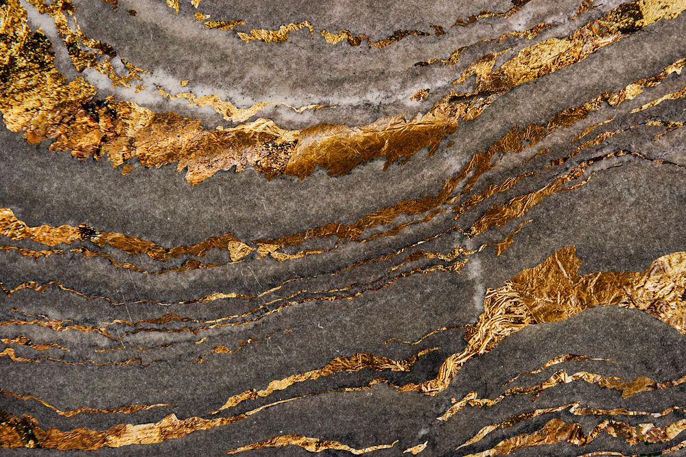 Gray marble rock with gold textured background
