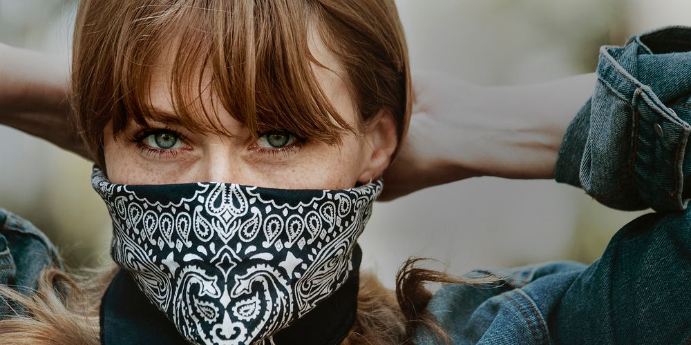 Woman covering her mouth and nose with a bandana during the coronavirus outbreak