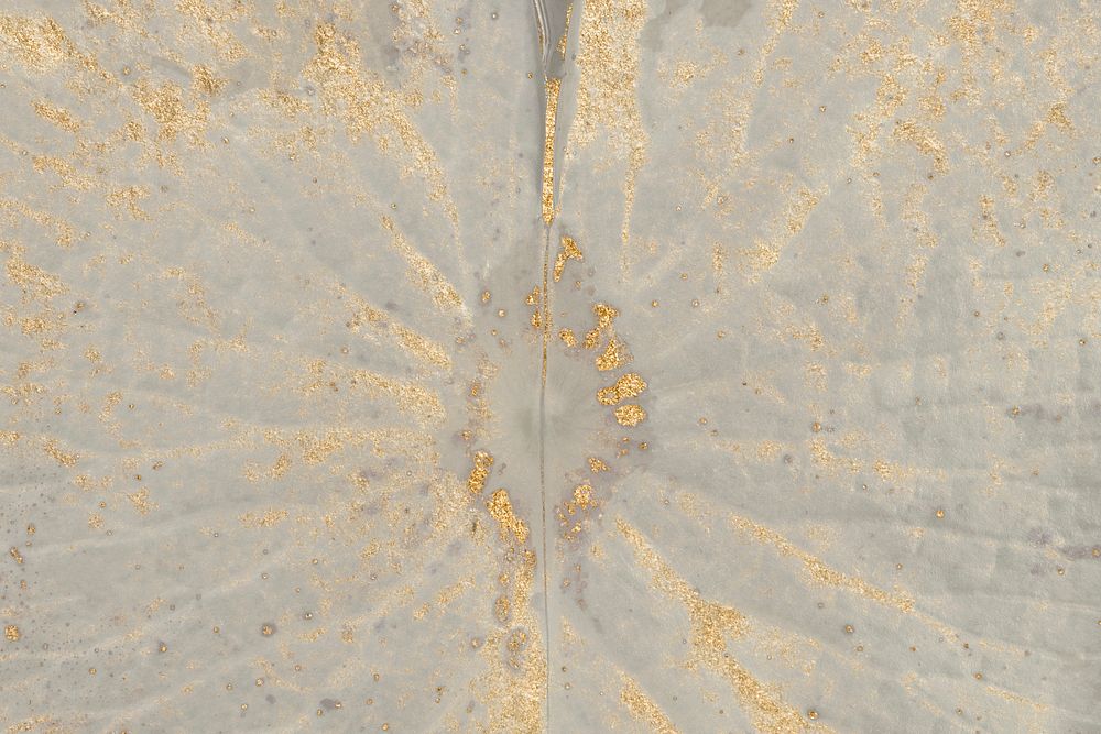 Gold glitter on water lily leaf macro background