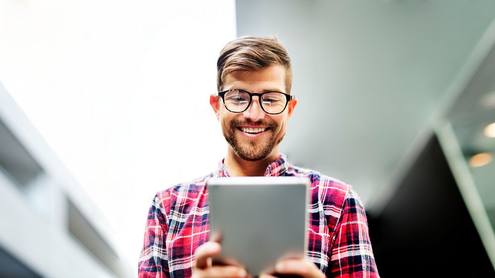 Cheerful man using a tablet