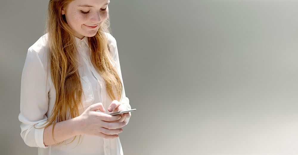 Young woman texting on her phone