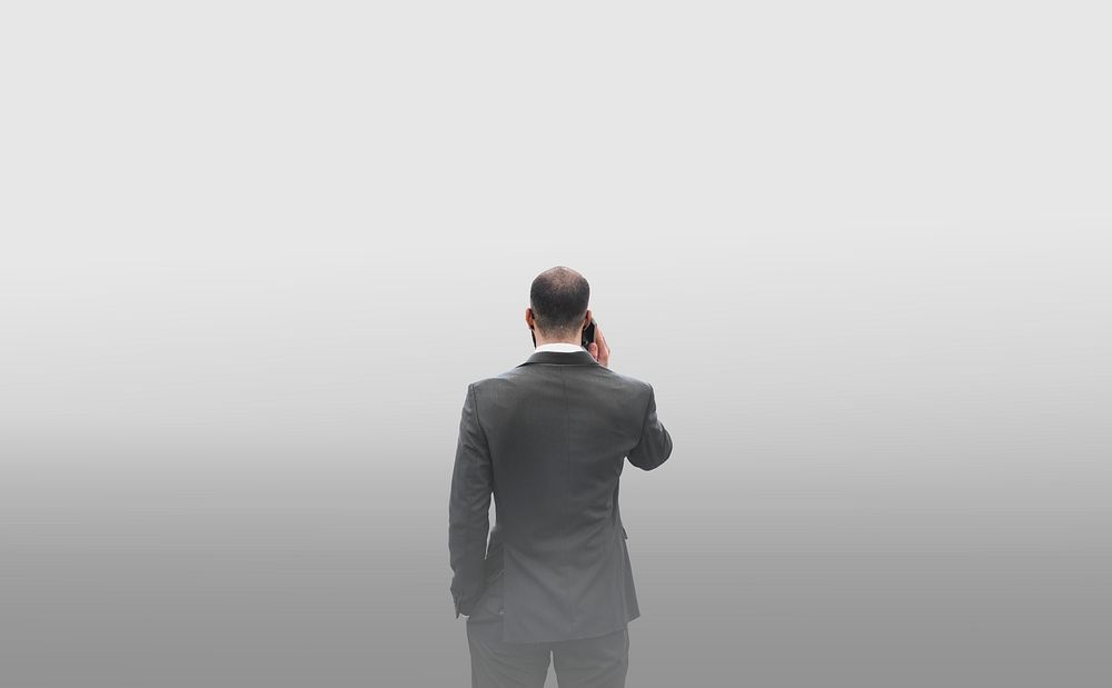 Rear view of a businessman talking on the phone in a smog