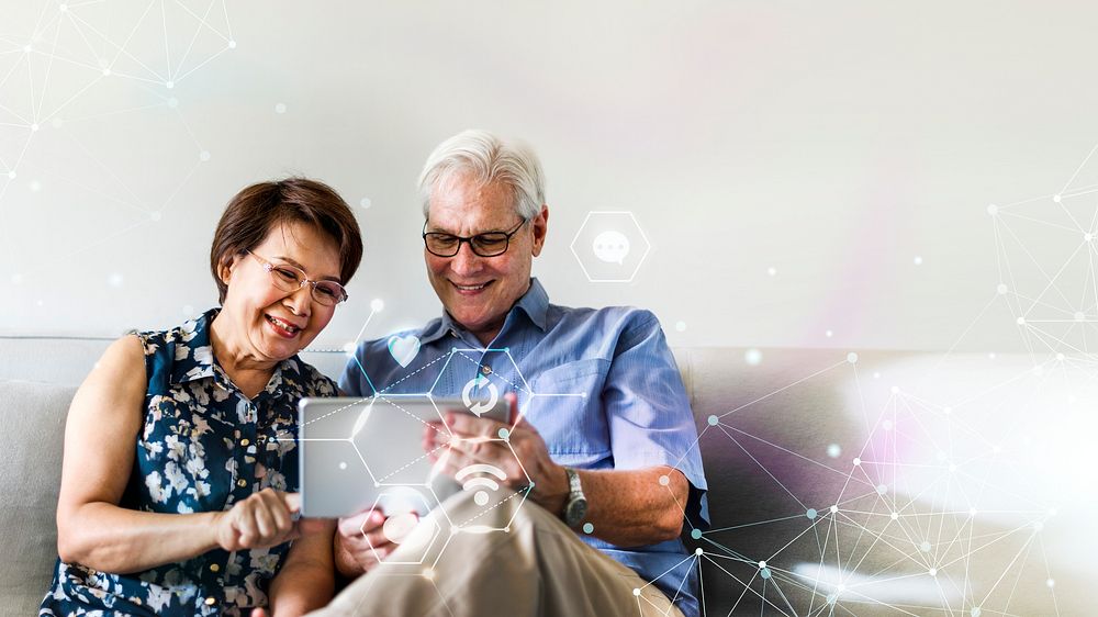 Senior couple using a digital device in a living room