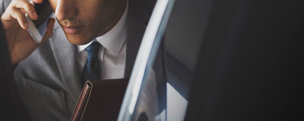 Businessman talking on the phone in a car