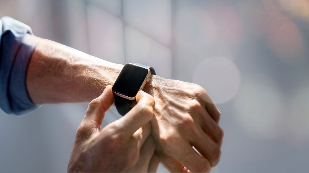 Man checking time from his smartwatch