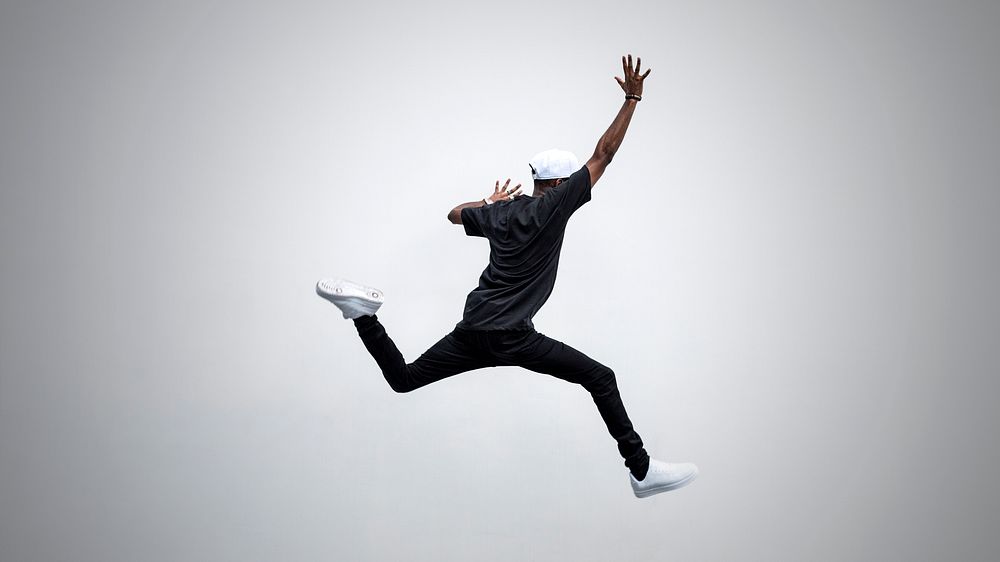 Black man jumping in to the air