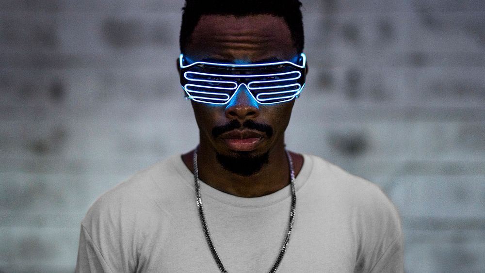 Young man wearing futuristic led glasses