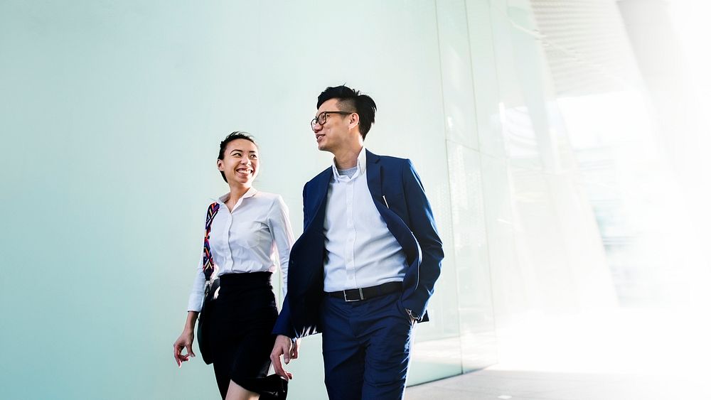 Cheerful Asian couple walking together