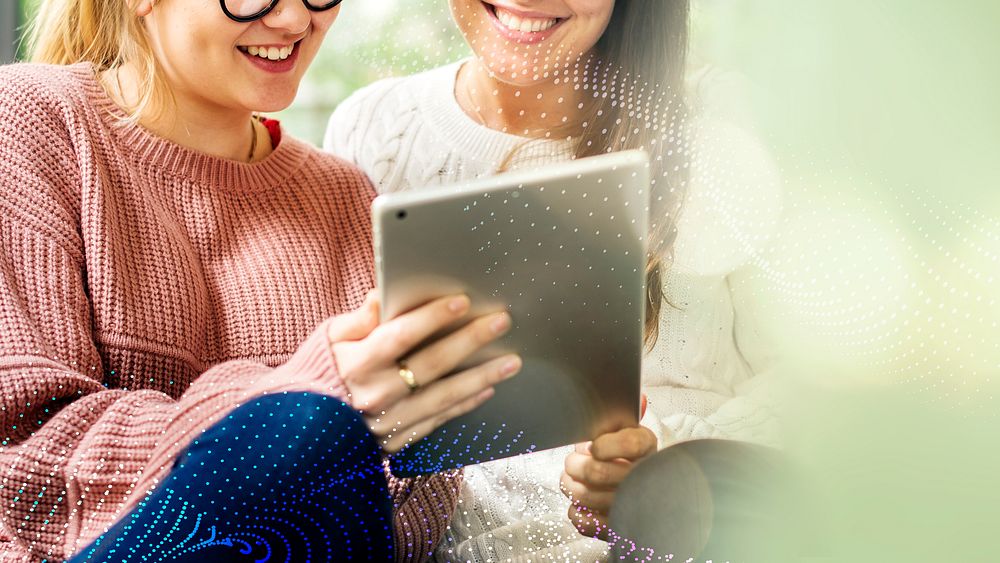 Women using a digital tablet together
