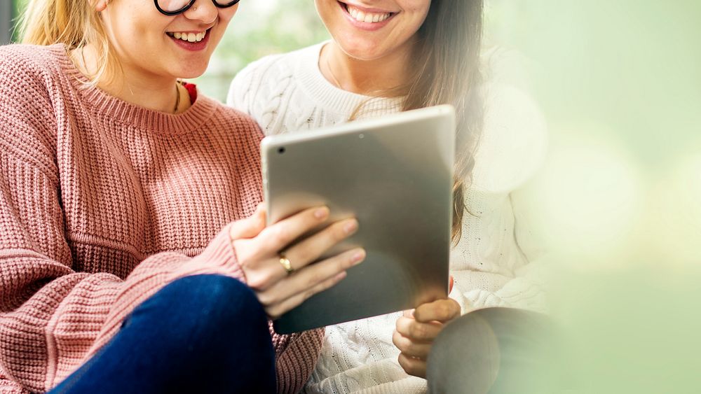 Women using a digital tablet together