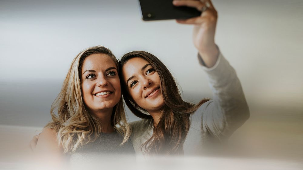 Happy lesbian couple taking a selfie