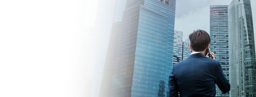 Rear view of a businessman talking on the phone in a city