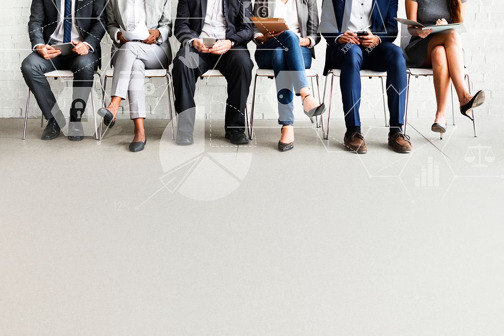 Group of diverse people sitting in a line on chairs