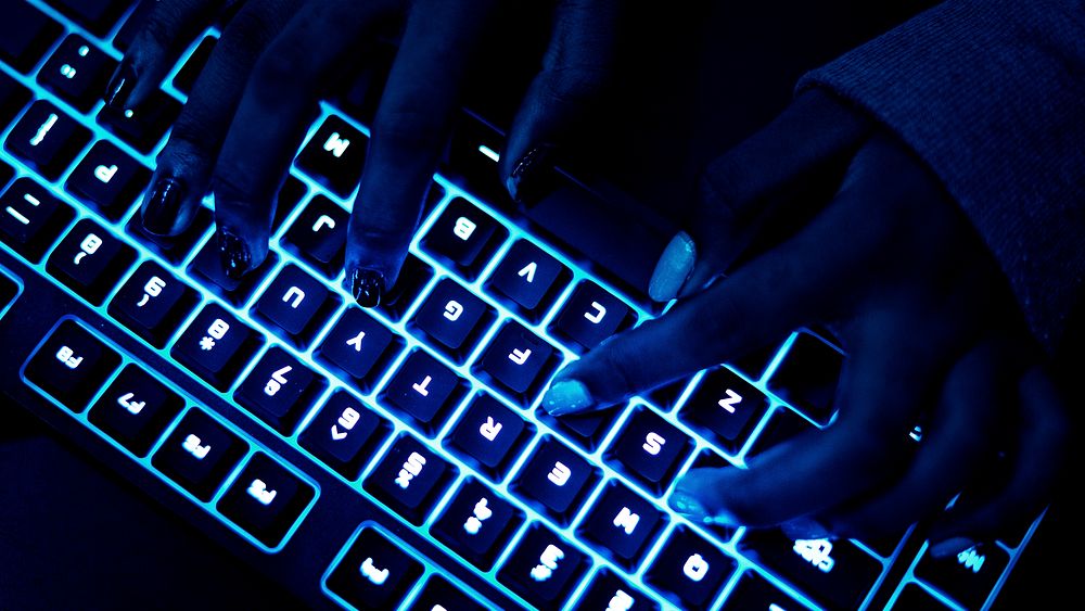 Closeup of hands using a keyboard