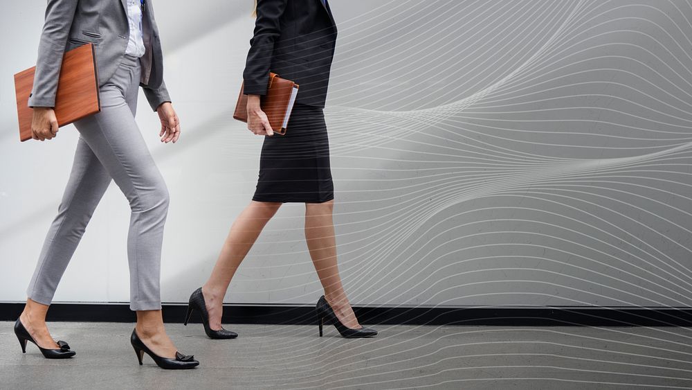 Two businesswomen walking in a corridor