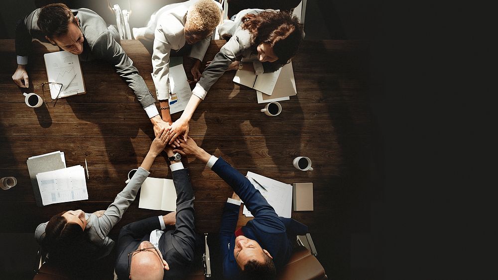 Business people joining hands as a team