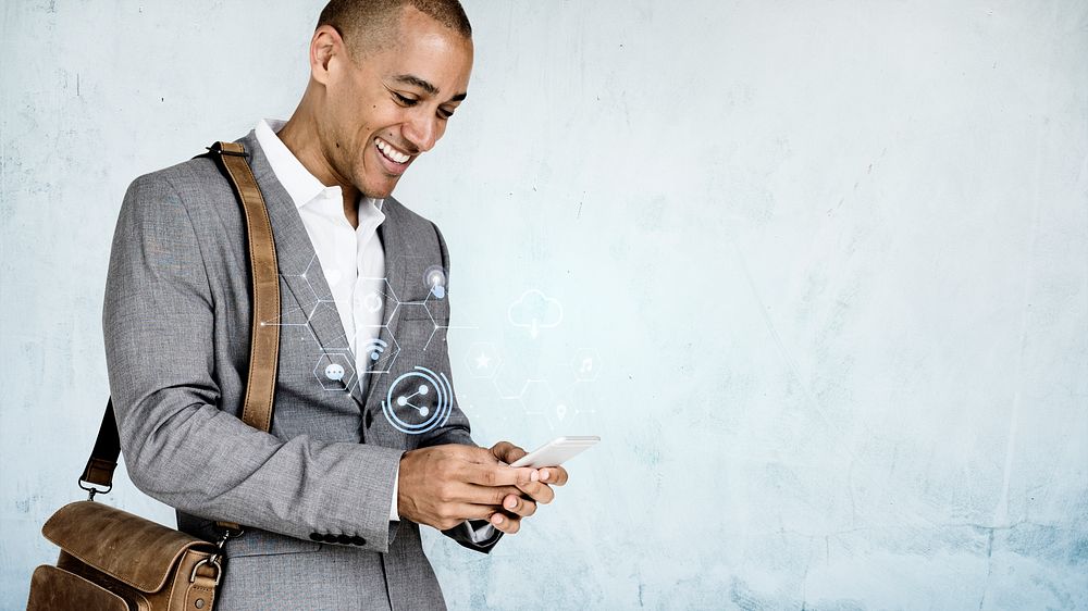 Cheerful businessman texting on his phone