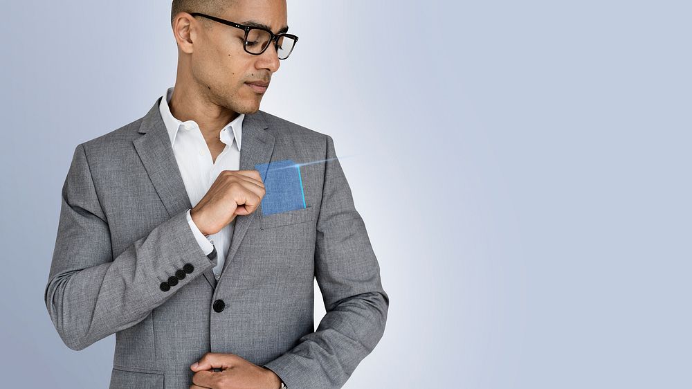 Casual man reaching for a translucent blue card from his suit pocket