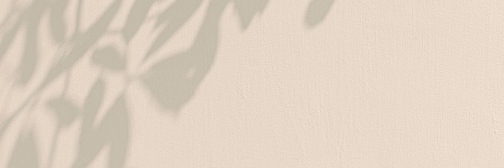 Leaves shadow on a beige wall 