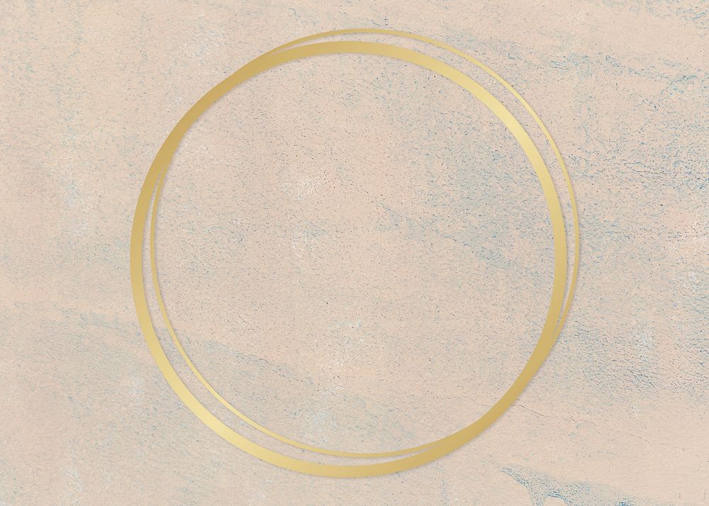 Gold round frame on a rough beige background
