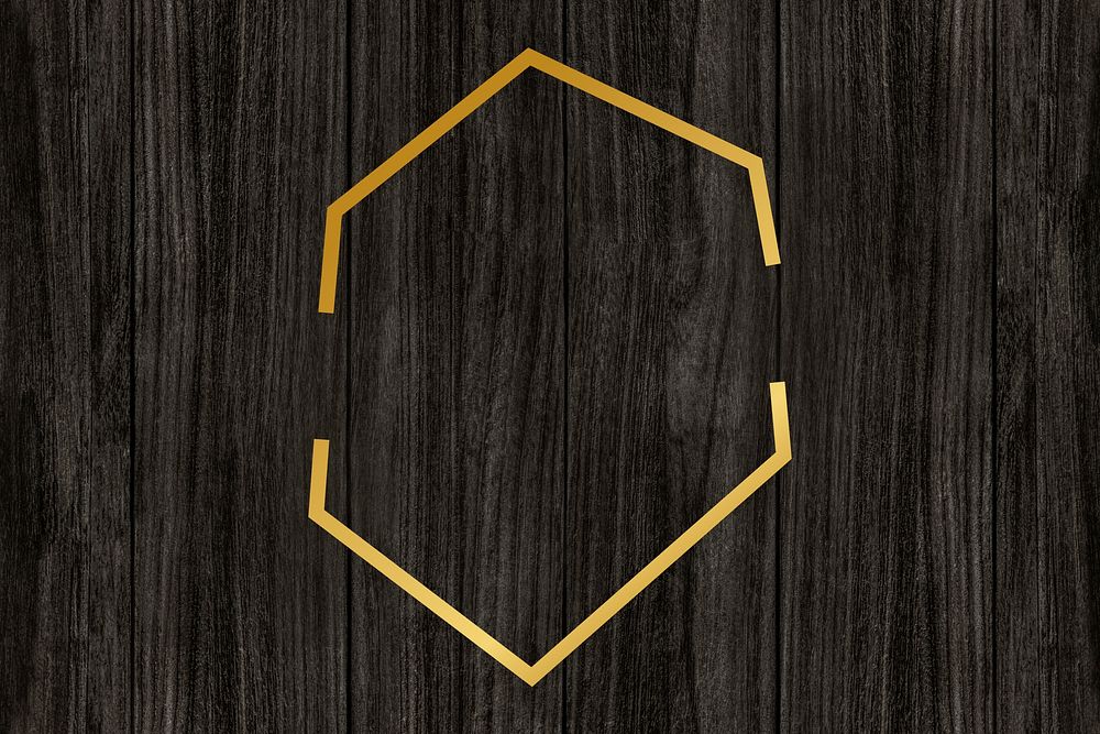 Gold hexagon frame on a wooden background