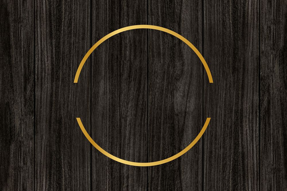 Gold circle frame on a wooden background