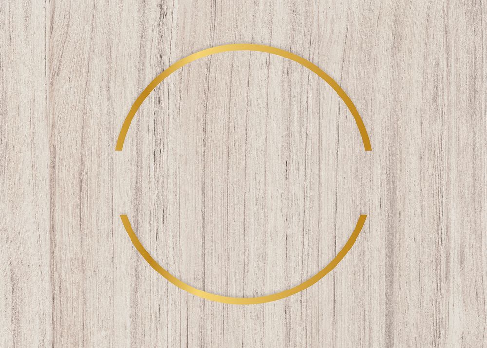 Gold circle frame on a wooden background