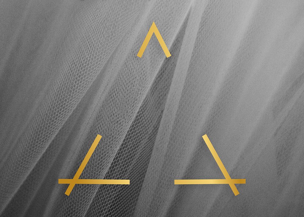Golden framed triangle on a gray fabric texture