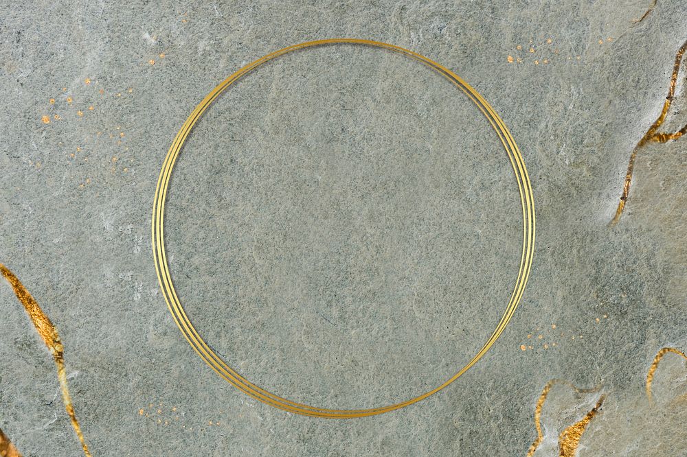 Round golden frame on a marble textured background