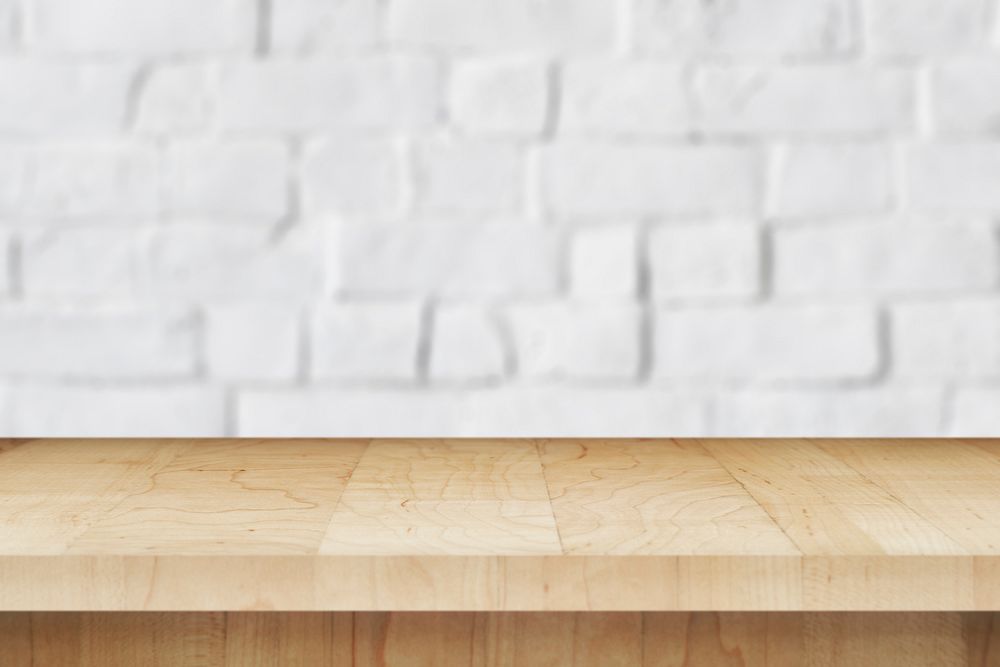 Wooden table a white brick wall product background