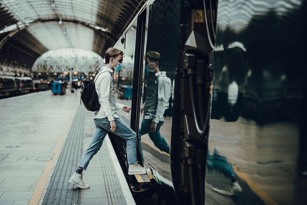 Man getting on a train from a platform