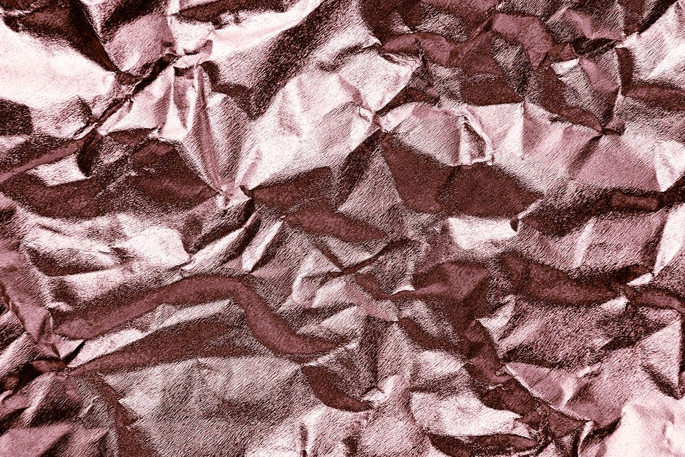 Crumpled rose gold paper textured background