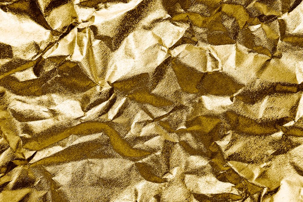 Crumpled gold paper textured background