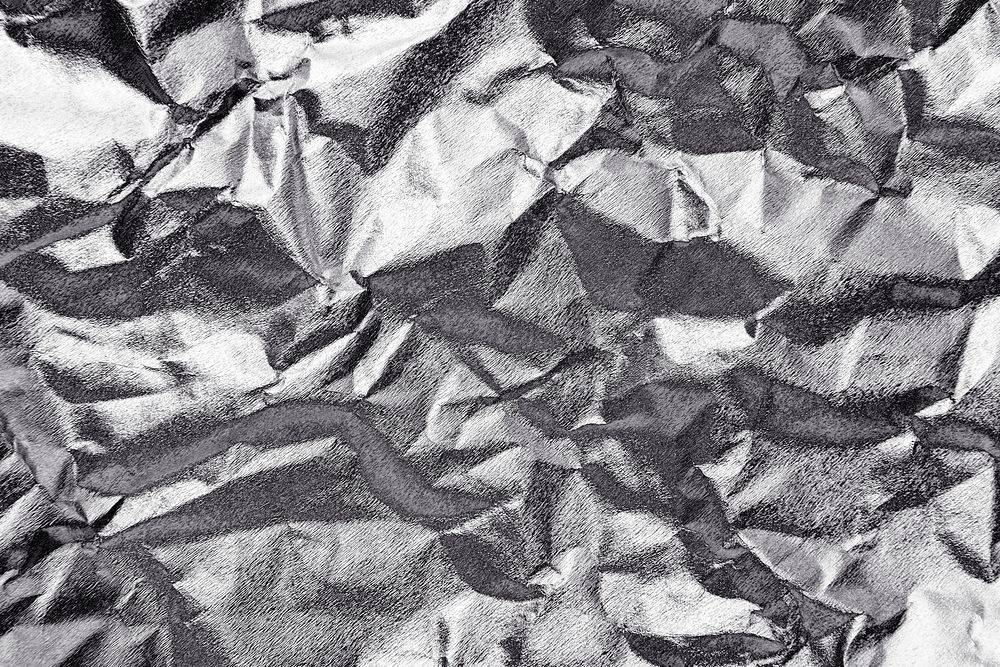 Crumpled silver paper textured background
