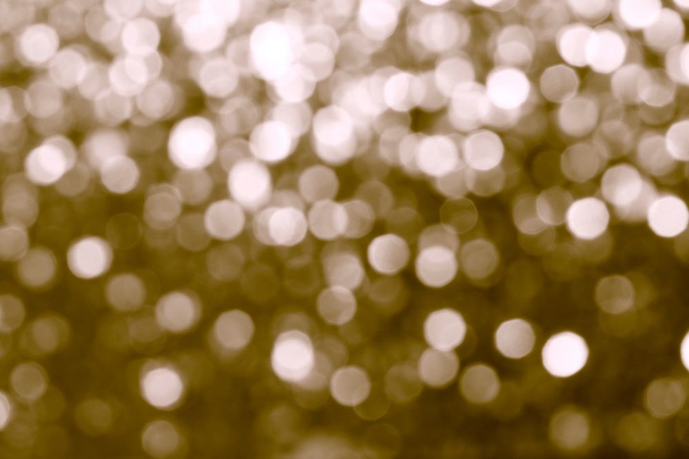 Blurry shiny gold glitter textured background