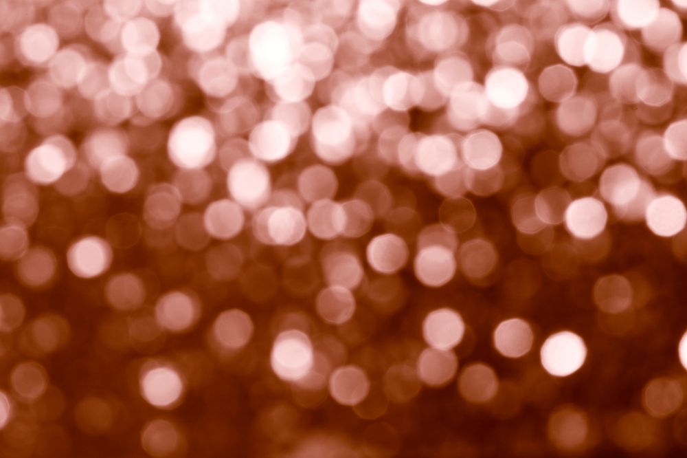 Blurry shiny copper glitter textured background