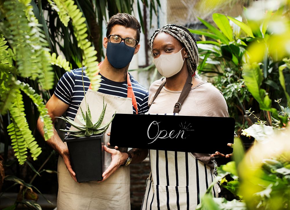 Florists in face mask with open sign during new normal