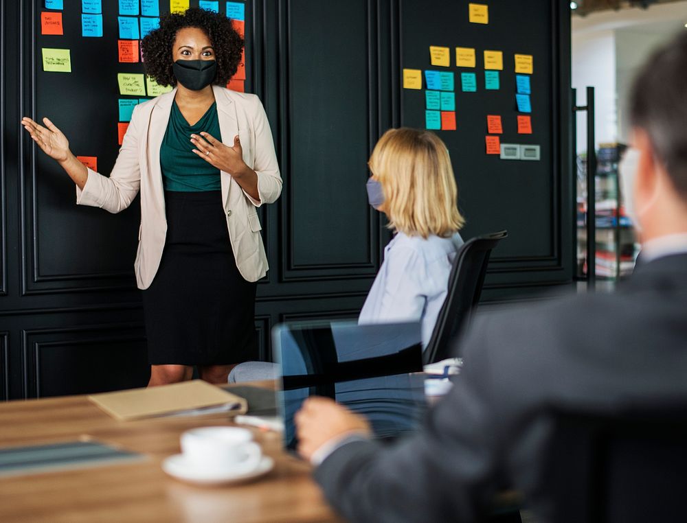 Businesswoman wearing mask in coronavirus meeting, the new normal