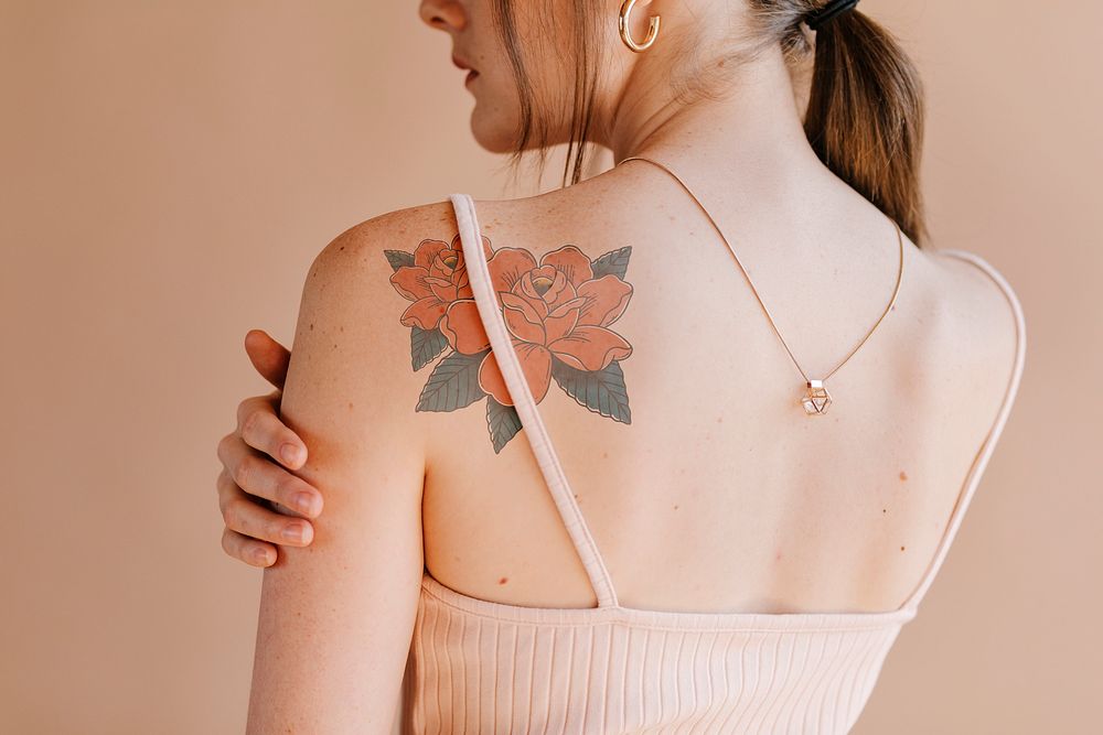 Rose tattoo design mockup psd on a woman’s shoulder 