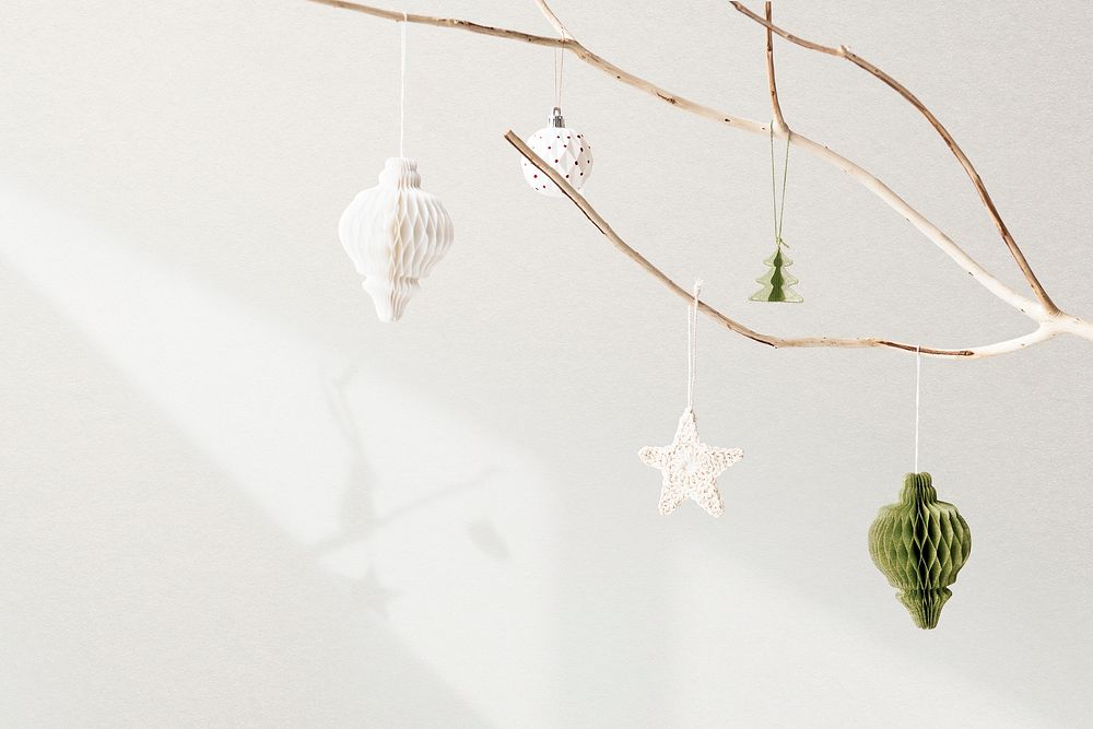 Christmas ornaments hanging on a tree on white background
