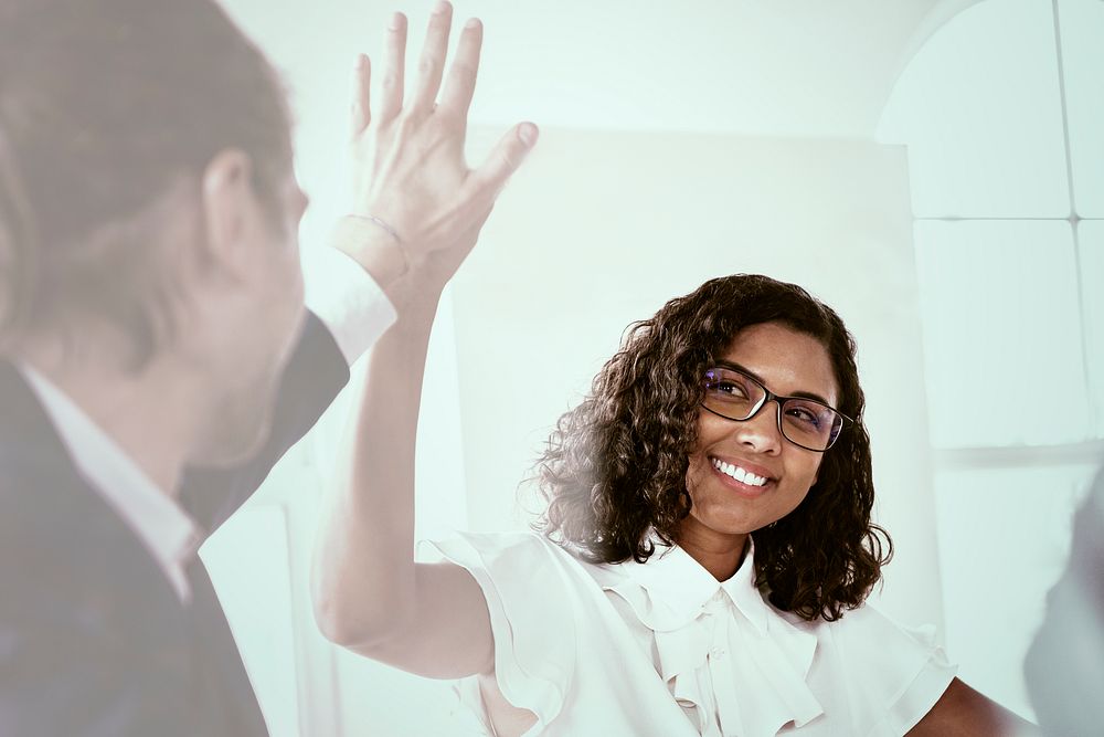 Businesswoman giving high five with colleague